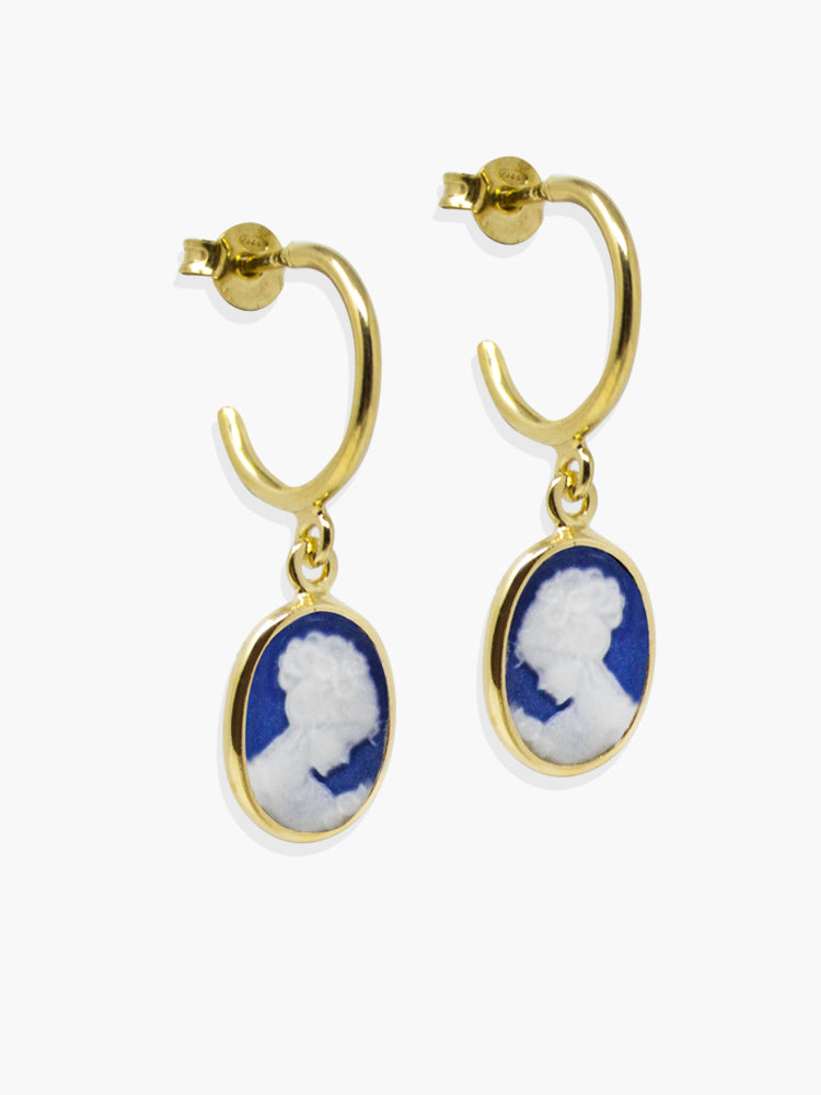 The Blue Mini Cameo Hoop Earrings by Vintouch Jewels feature dangling blue cameo pendants on gold hoops, handcrafted in Italy from sustainable materials and adorned with a classical profile portrait.