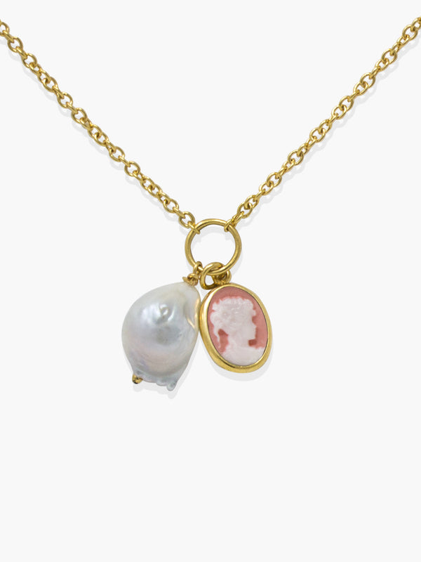 The Pink Mini Cameo With A Pearl Necklace by Vintouch Jewels features a gold chain with a round pearl charm and an oval cameo pendant adorned with a woman’s profile, exemplifying exquisite Italian craftsmanship.