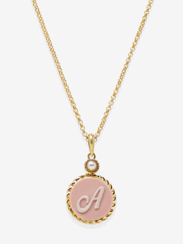 A pink cameo pendant hand-carved from porcelain, styling an elegant letter A