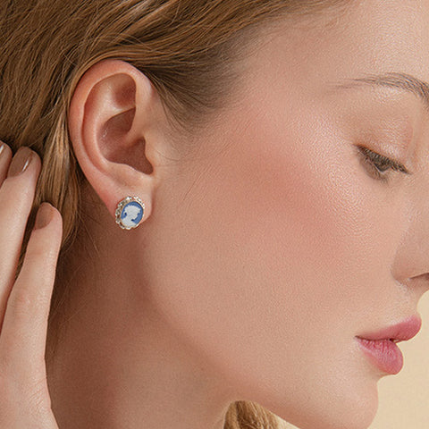 Profile view of a woman wearing blue cameo earrings in sterling silver, handcrafted in Italy