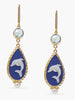 Dolphins cameo earrings by Vintouch are handcrafted from porcelain, showcasing swimming dolphins, symbolizing wisdom and salvation as per the Greek mythology, enriched with sparkling blue topaz. 