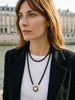 Woman wearing the long Star Dancer cameo necklace with black onyx beads in a double-layer style