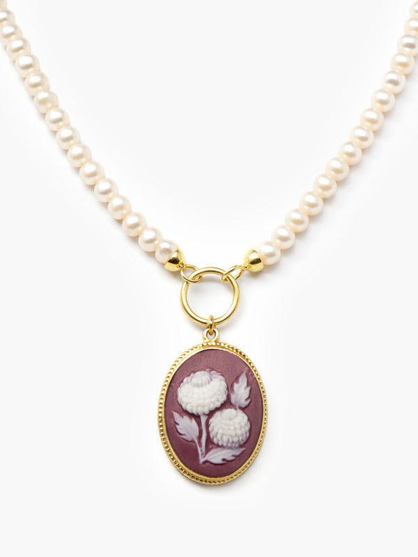 Handcrafted pearl necklace with burgundy porcelain cameo pendant depicting a white pompon flower, mounted in 18k gold-plated sterling silver