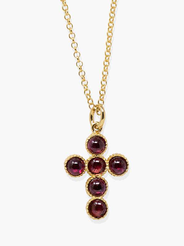 Hope gold-plated silver cross necklace set with six deep red rhodolite gemstones.