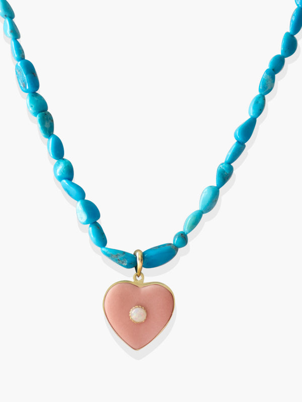 Turquoise necklace with a pink porcelain heart pendant and central opal, handcrafted Vintouch jewelry photographed on a neutral background.