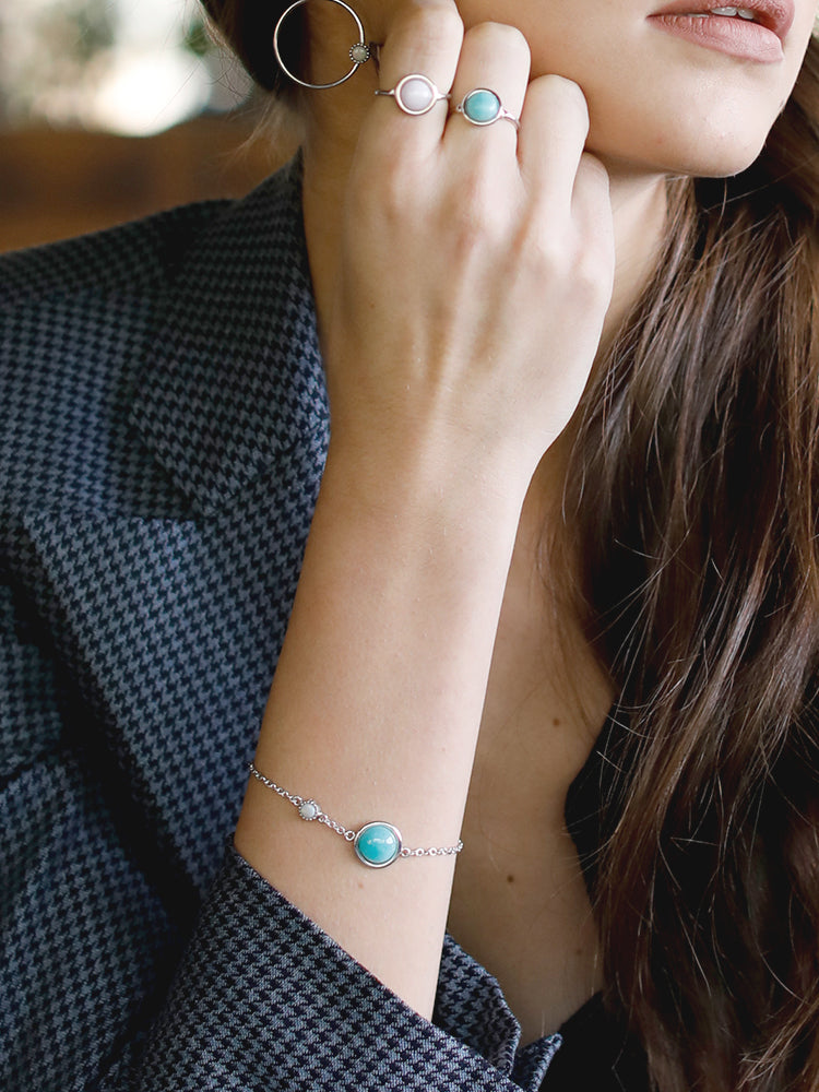 Amazonite for positive energy. Vibrant and full of style, our Satellites collection brings semi-precious gemstones to life for a fresh everyday look. This bracelet features Amazonite and Opal stones set in sterling silver. The chain size is adjustable. 