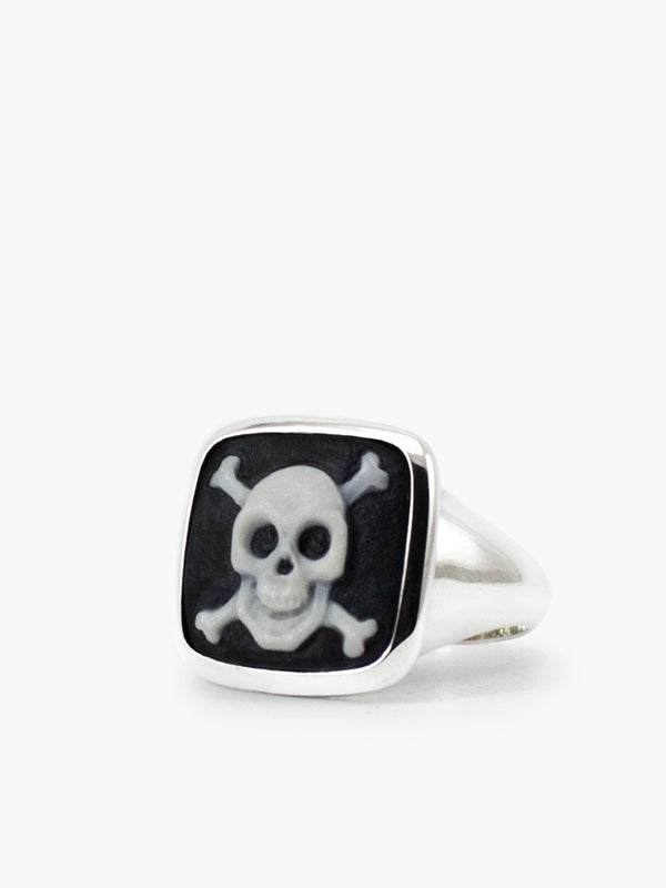 The Skull & Crossbones Cameo cameo ring depicts this universal hazard symbol through a fancy and ironic design. Skulls also symbolize courage and protection. It's carefully hand-carved from porcelain in our workshop in Italy and bezel-set in sterling silver, presented in its 100% plastic-free, eco-friendly Vintouch signature packaging.