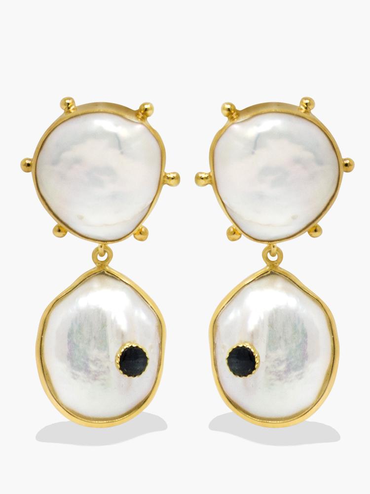 The Rebel Rebel Earrings feature glossy pearls each set in glam-rock inspired studded settings. Handmade from 18k gold-plated silver, they're enriched by two genuine blue sapphire stones set in the pearls. 