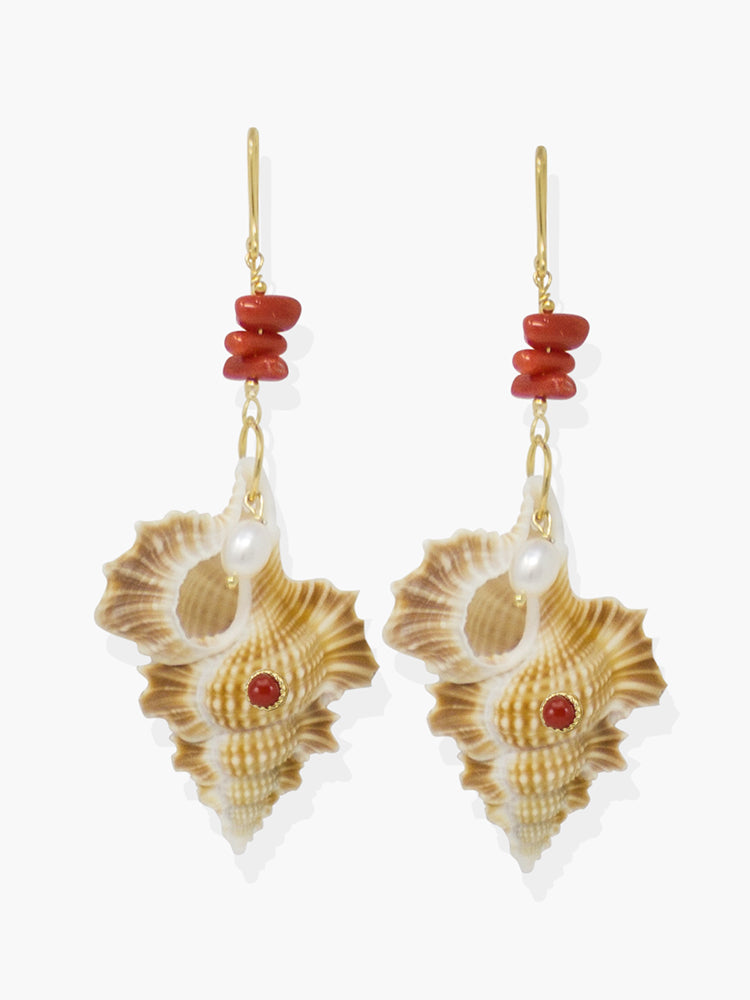 Featuring red coral and pearls, these earrings are cast from 18k gold over silver with a couple of cymatium shells whose shape reminds of Africa.